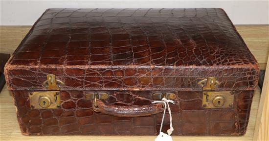 A crocodile skin suitcase, by Barkers, Kensington